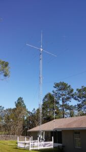 A tall metal tower with wires hanging from it's sides.