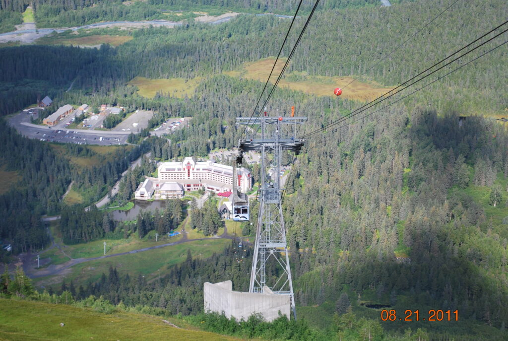 A cable car is going up the mountain.