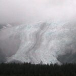 A large mountain with snow on it's side.