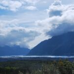 A view of the mountains and water from a hill.