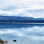 A body of water with mountains in the background.