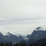 A view of some mountains with snow on them.