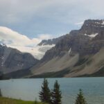 A lake with mountains in the background