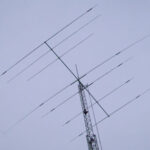 A tall metal tower with many wires hanging from it.